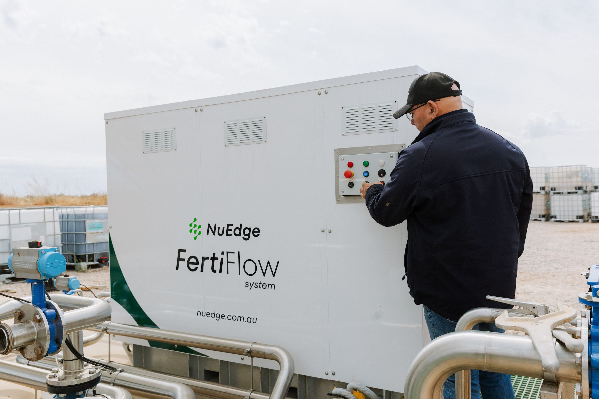 Operator using the control panel on the automated NuEdge FertiFlow on-site fertiliser batching system.