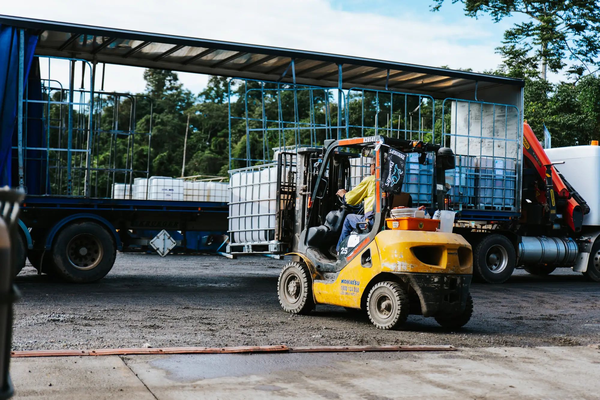 Forklift transporting liquid fertiliser onto a truck at an Australian farm, highlighting agronomy and custom fertiliser by NuEdge.