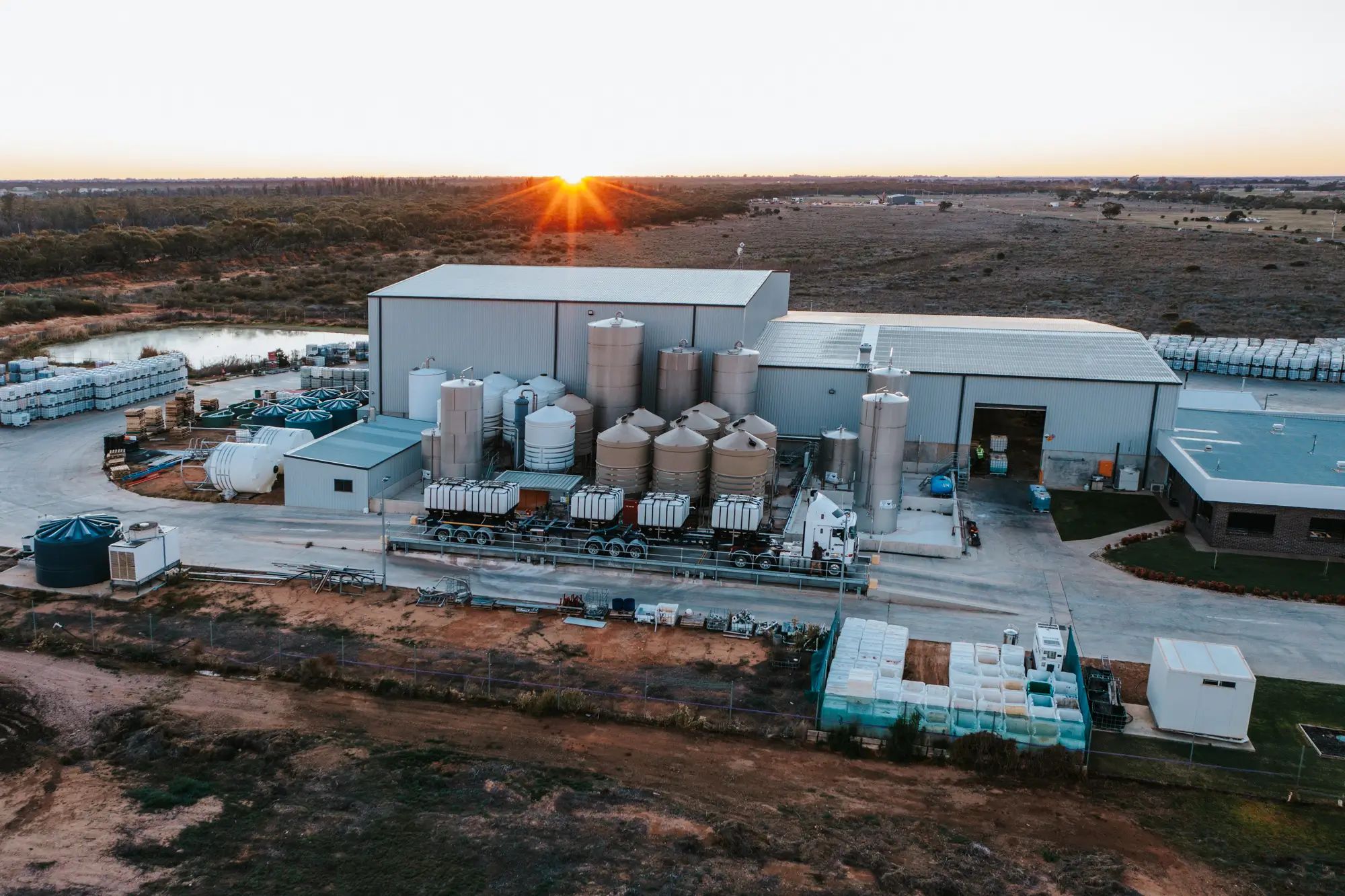 Fertiliser plant on an Australian farm at sunset, producing liquid fertiliser for agronomy and healthy crops with NuEdge.