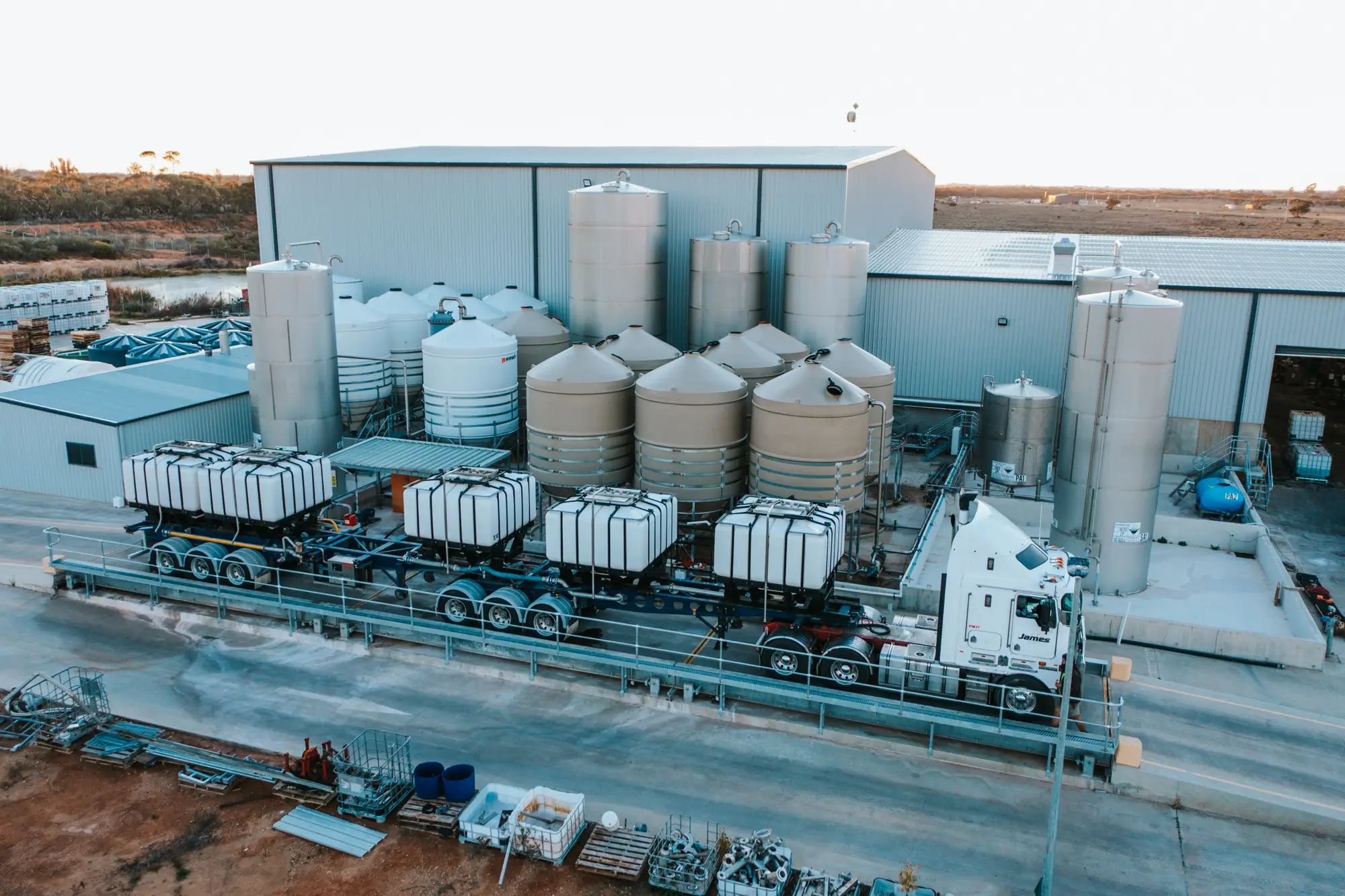 Fertiliser storage tanks at an Australian farm being loaded onto a truck. Key for agronomy and higher fruit yields with NuEdge.